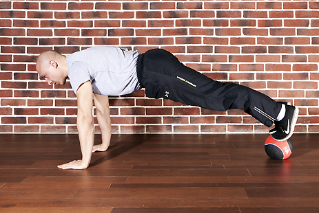 Floor press with feet on medicine ball